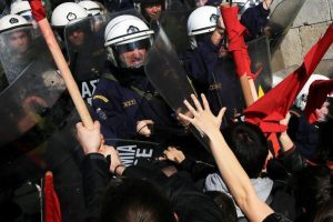 Protesters clash with riot police during a demonstration outside the parliament building against planned government reforms in Athens