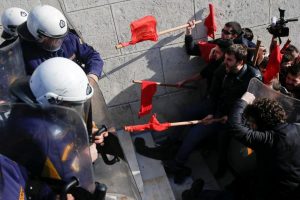 Protesters clash with riot police during a demonstration outside the parliament building against planned government reforms in Athens