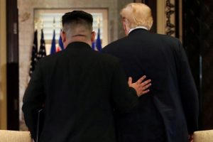 U.S. President Donald Trump and North Korea's leader Kim Jong Un leave after signing documents, at their summit in Singapore